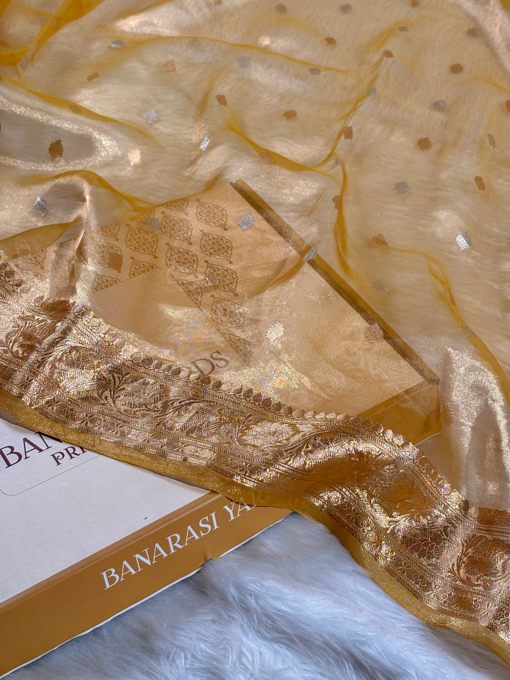 Pure tishu silk handloom banarasi saree features delicate Alfi Mina Buti motifs—intricate floral patterns rendered in fine zari weaving.