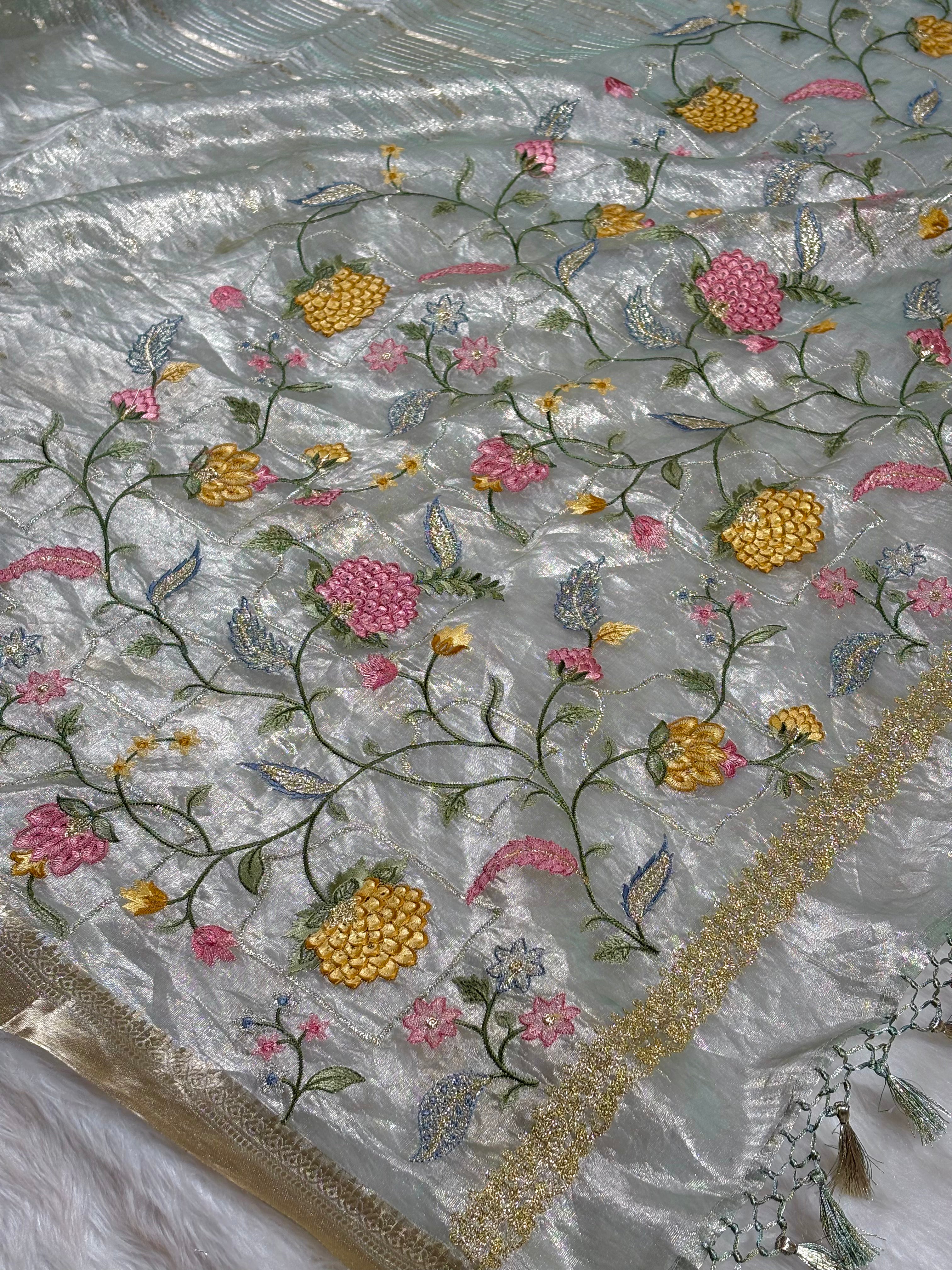 Pure Tishu Silk Banarasi Saree With elegant piece features delicate floral embroidery across the pallu and blouse pcs.