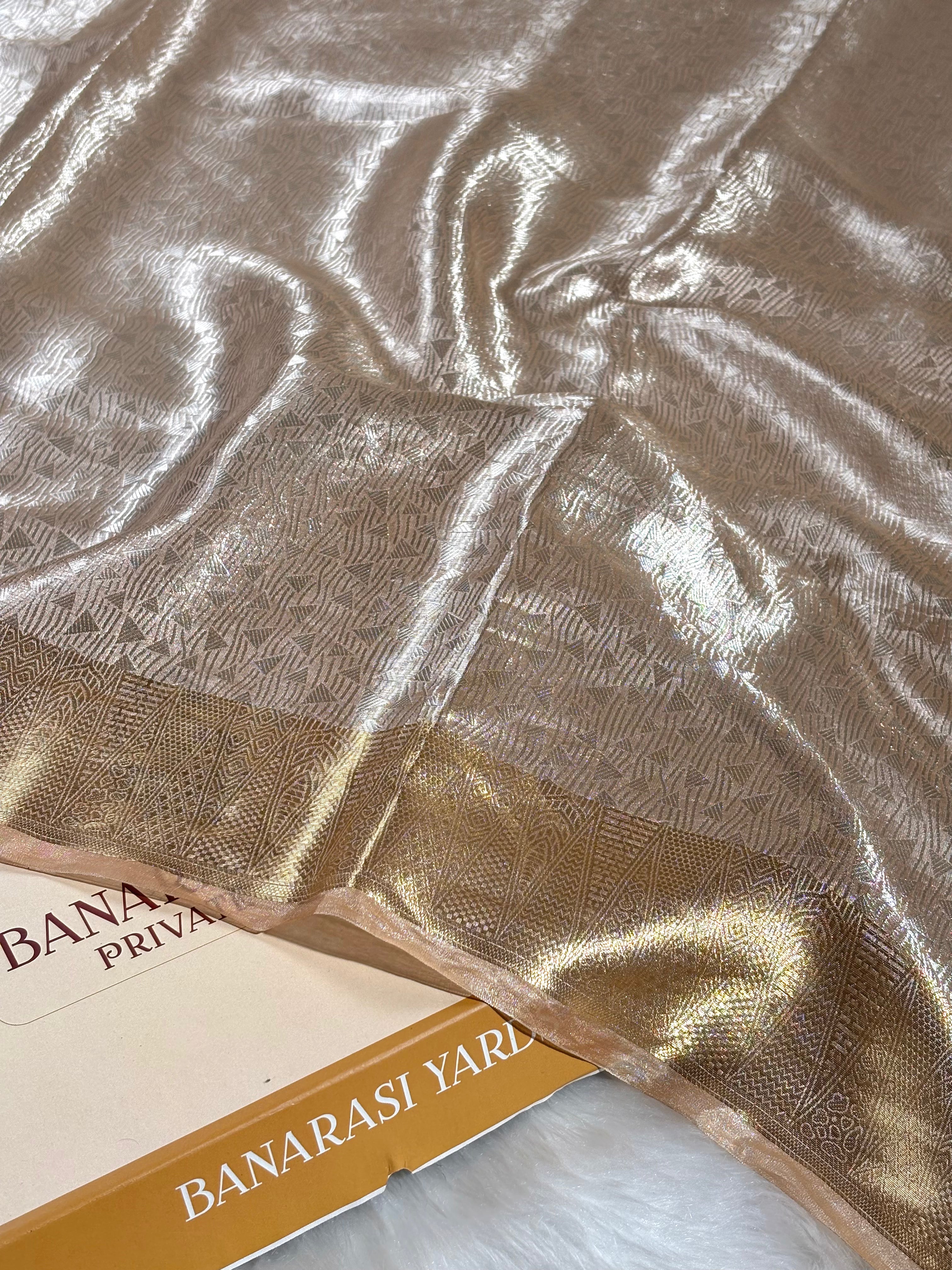 Pure Molten Tishu Banarasi Saree, crafted on traditional looms in Varanasi. This exquisite six-yard drape showcases the lustrous sheen of molten tishu weave—a lightweight silk blend that flows with ethereal grace.