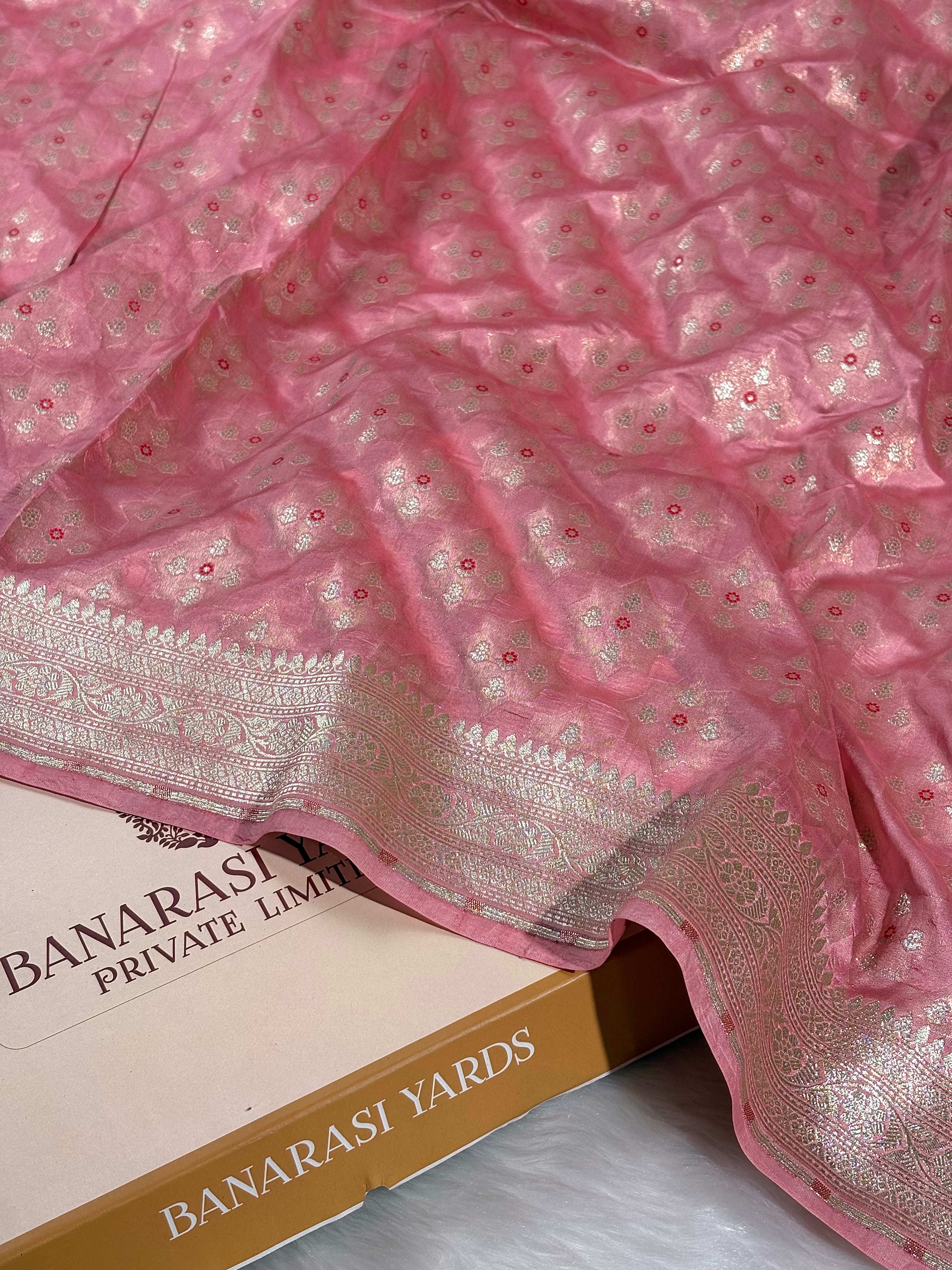 This exquisite Banarasi saree showcases intricate Alfi Mina detailing—delicate floral motifs interwoven with precision and artistry.