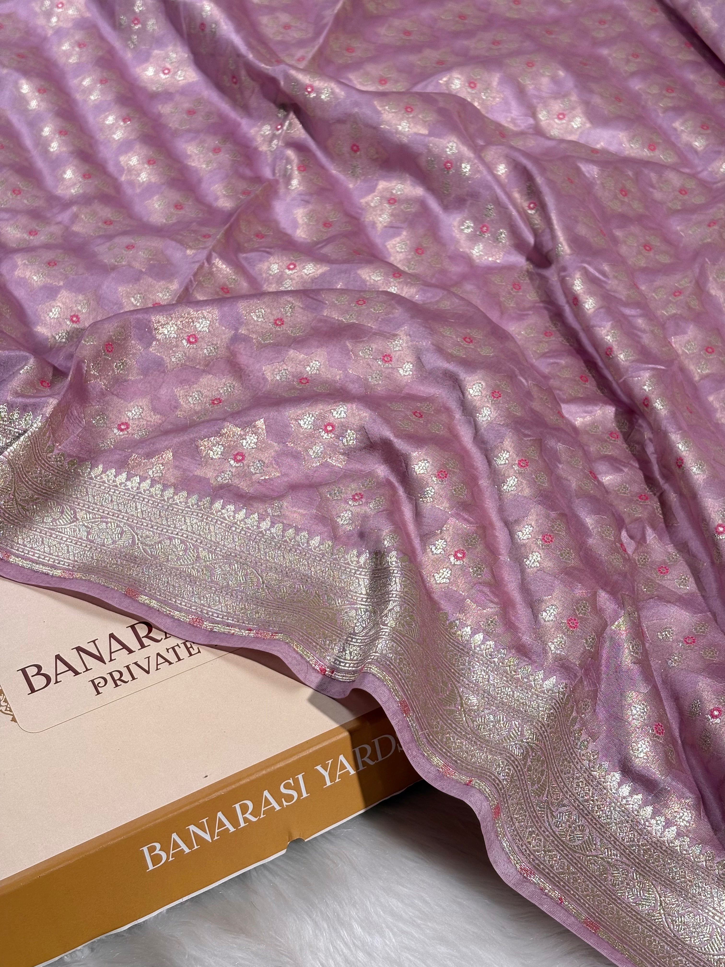  This Alfi Banarasi saree showcases delicate mina work across traditional patterns. Each motif is meticulously crafted on heritage looms, blending centuries-old weaving techniques with refined elegance. 