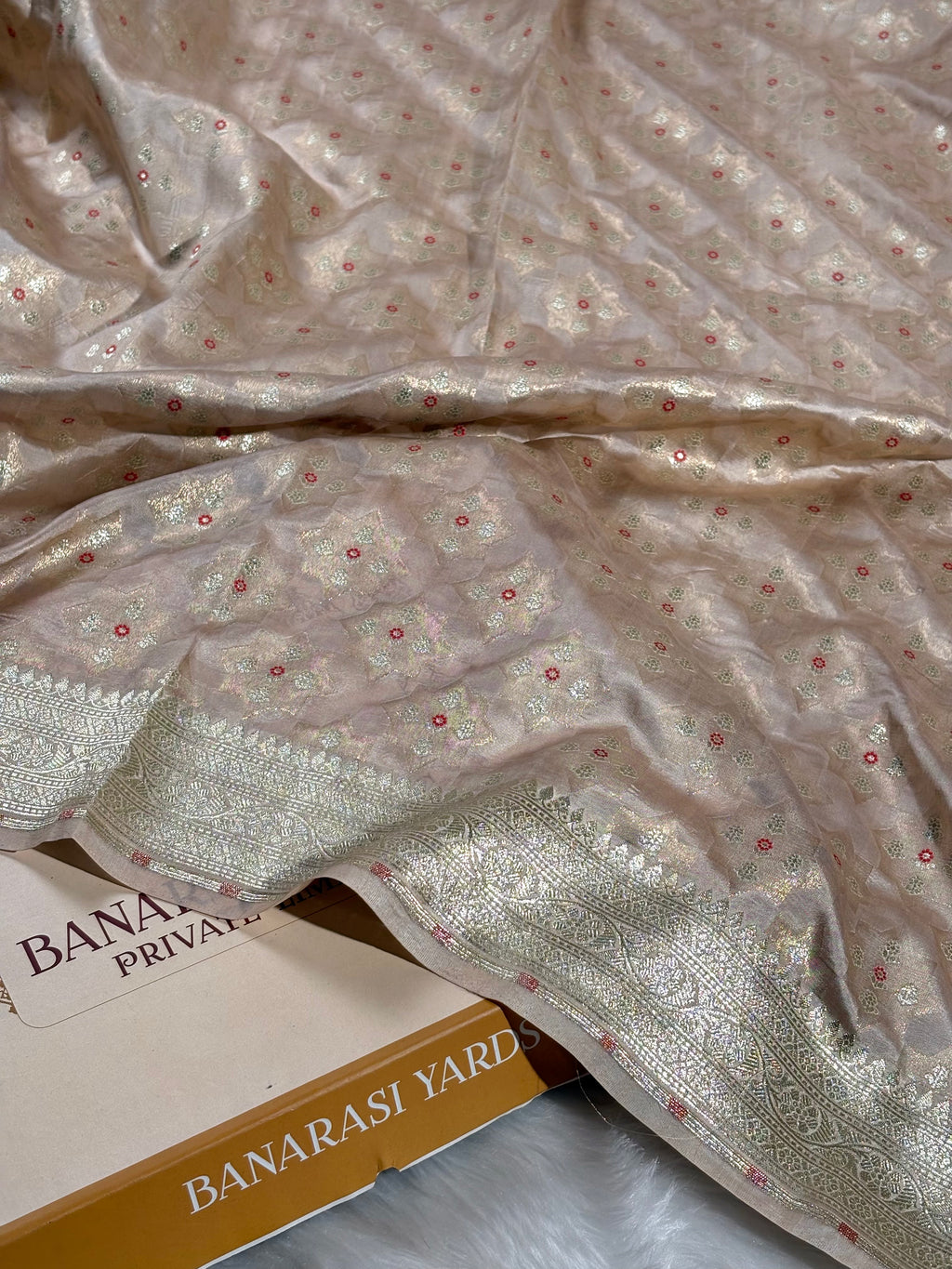 Woven on traditional looms in Varanasi, this Pure Katan Silk Banarasi Saree showcases the intricate Alfi Mina technique—delicate floral motifs meticulously crafted into lustrous silk saree.