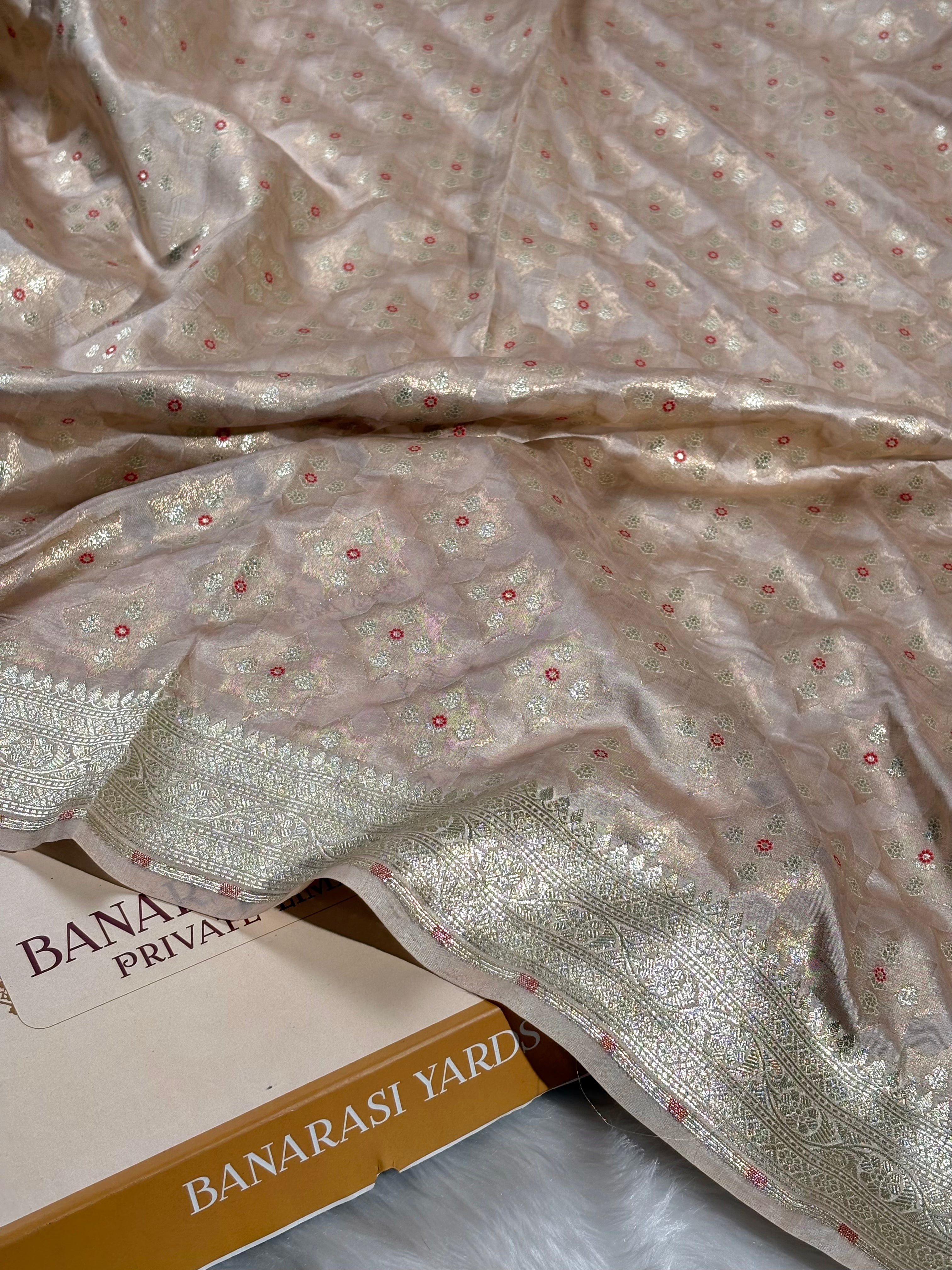 Woven on traditional looms in Varanasi, this Pure Katan Silk Banarasi Saree showcases the intricate Alfi Mina technique—delicate floral motifs meticulously crafted into lustrous silk saree.