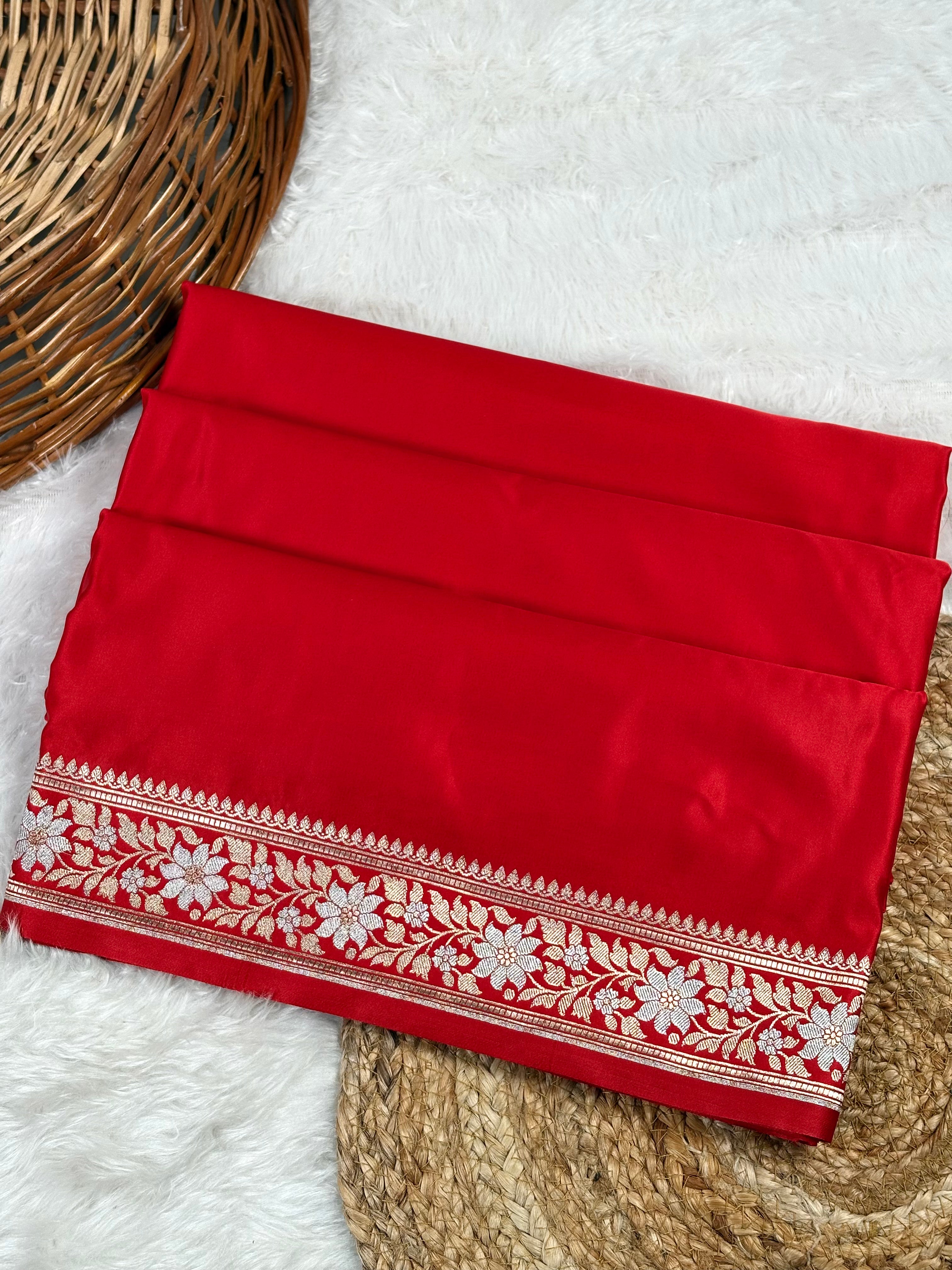 mashru katn banarasi saree, featuring a detailed sona rupa floral border, displayed on a white faux fur rug with a basket.