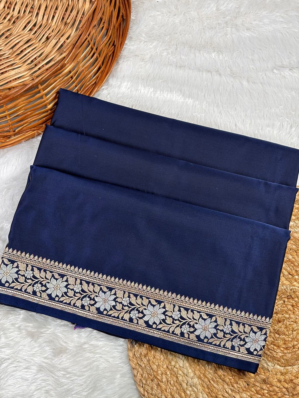 Navy blue saree featuring a detailed floral border in sona rupa concept